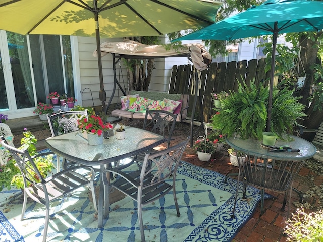 view of patio / terrace featuring outdoor dining area and fence