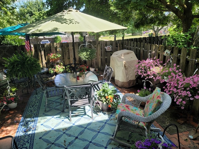 view of patio / terrace with outdoor dining area, fence private yard, and grilling area