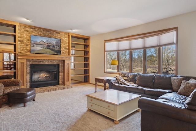 living room featuring built in features, carpet floors, and a brick fireplace