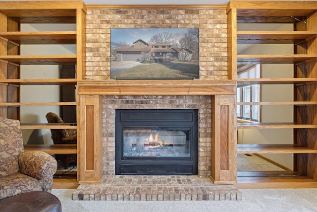 unfurnished living room featuring a brick fireplace and carpet flooring