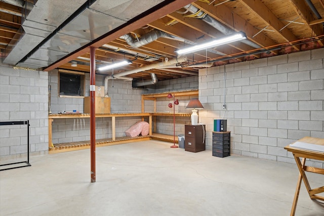 unfinished basement featuring a workshop area