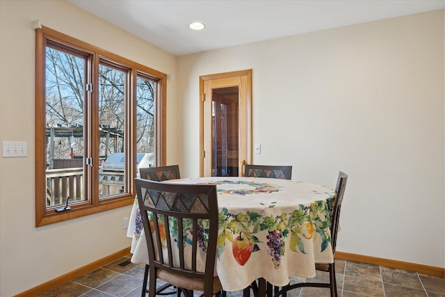 dining area with visible vents, recessed lighting, stone finish flooring, and baseboards