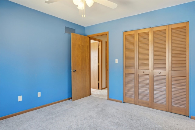 unfurnished bedroom with carpet, visible vents, a closet, and baseboards