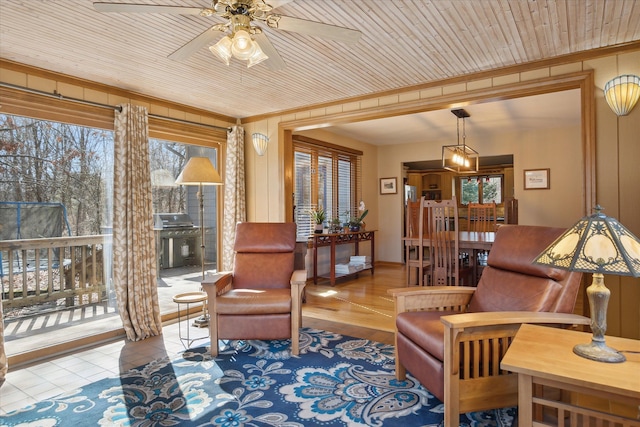 interior space with wood ceiling and ceiling fan