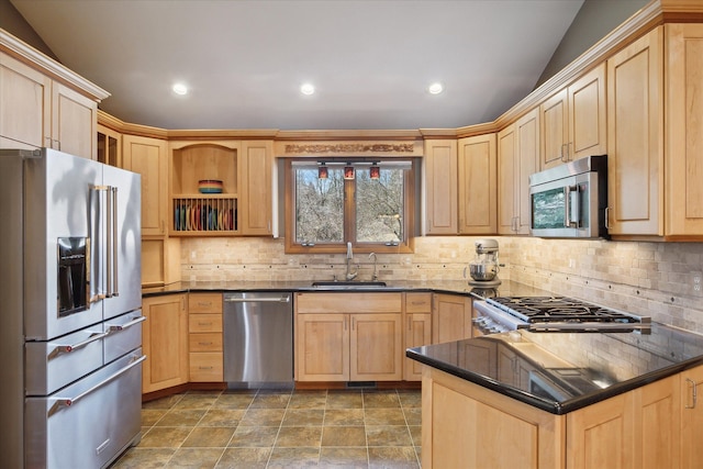 kitchen featuring backsplash, light brown cabinets, appliances with stainless steel finishes, and a sink