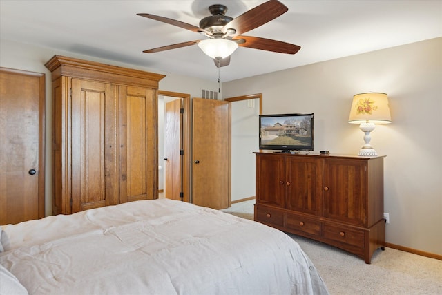 bedroom with light carpet, ceiling fan, and baseboards