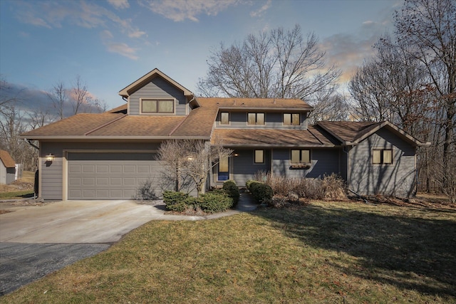 view of front of house with driveway, a front yard, and a garage