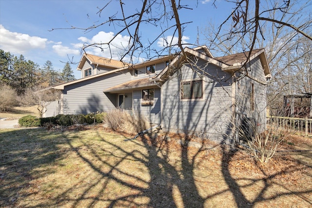 view of property exterior featuring a lawn and a garage