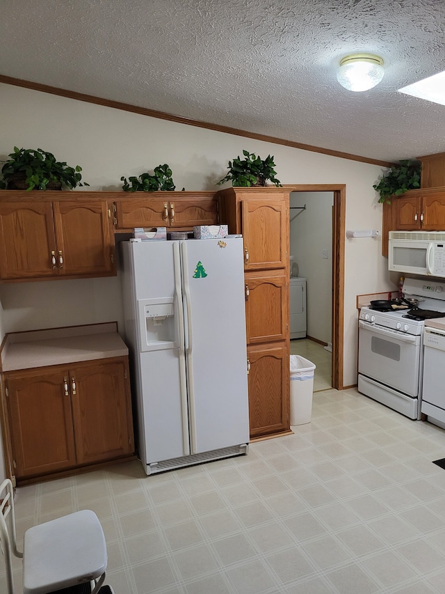 kitchen featuring white appliances, light floors, washer / clothes dryer, vaulted ceiling, and crown molding