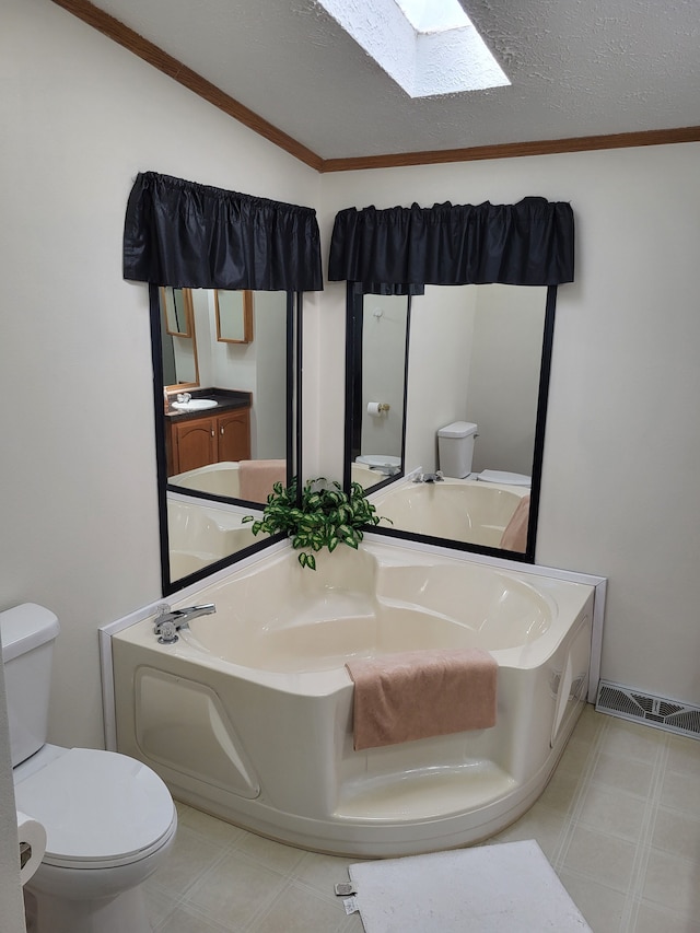 full bathroom with visible vents, toilet, a textured ceiling, a skylight, and vanity