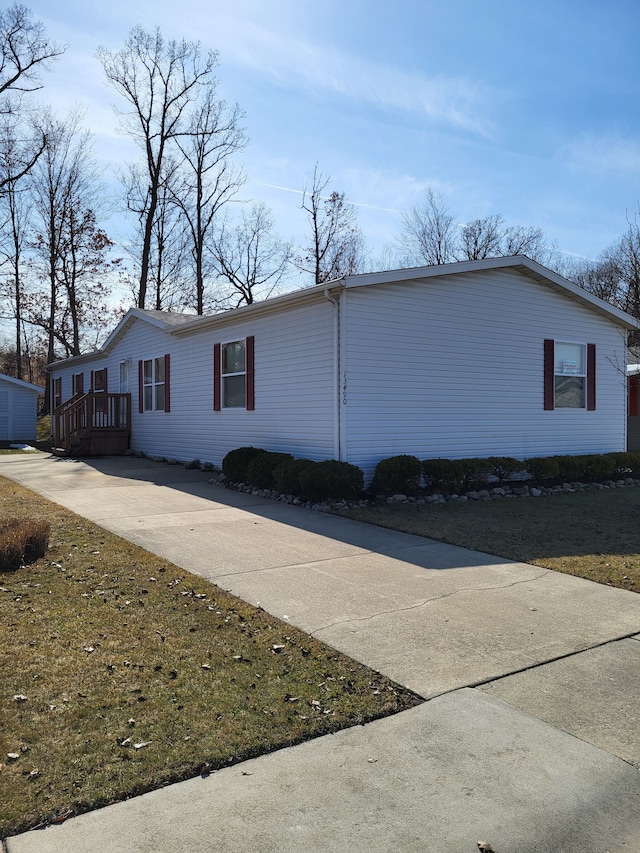 view of home's exterior with concrete driveway