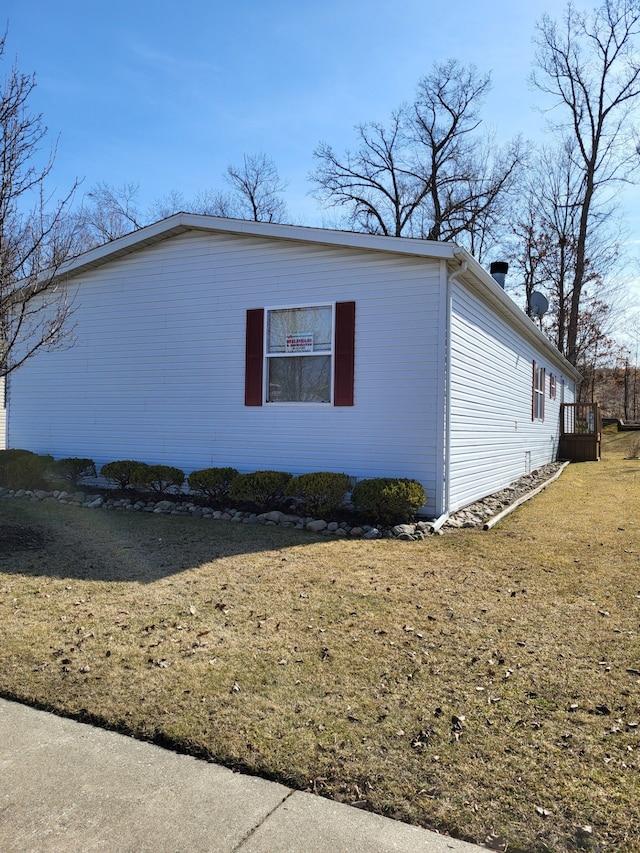 view of side of property with a yard