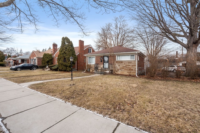 view of front facade featuring a front yard and brick siding