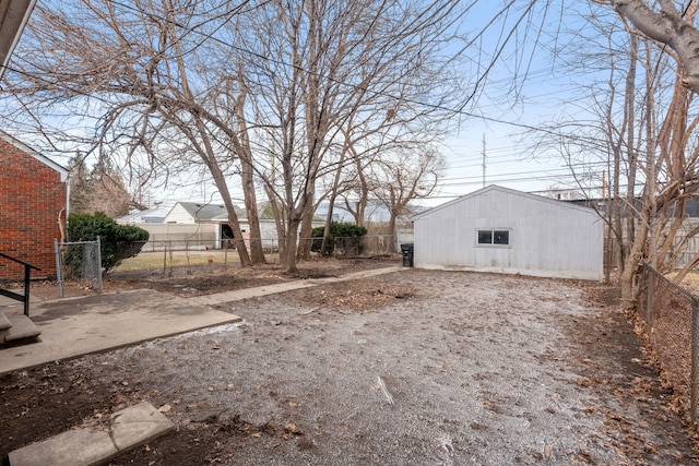 view of yard featuring an outbuilding and fence private yard