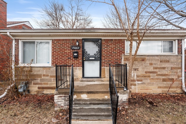 view of exterior entry with brick siding