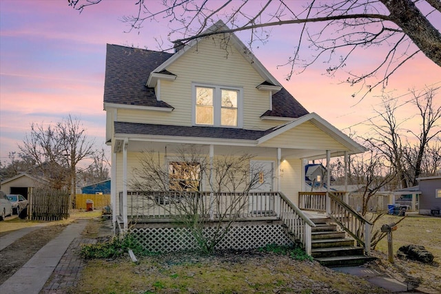 view of front of home with a porch and roof with shingles