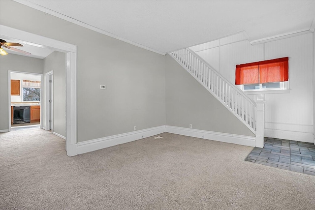 unfurnished living room with beverage cooler, carpet flooring, and stairs