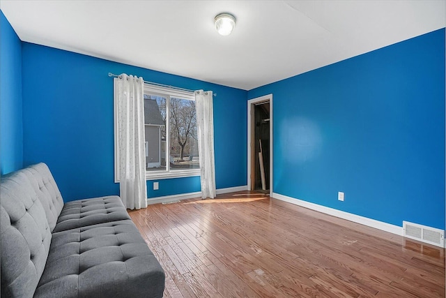 unfurnished room with visible vents, baseboards, and wood finished floors