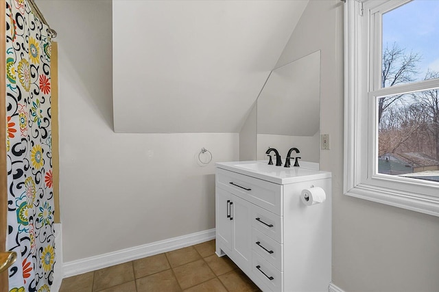 bathroom featuring baseboards, lofted ceiling, vanity, and tile patterned flooring