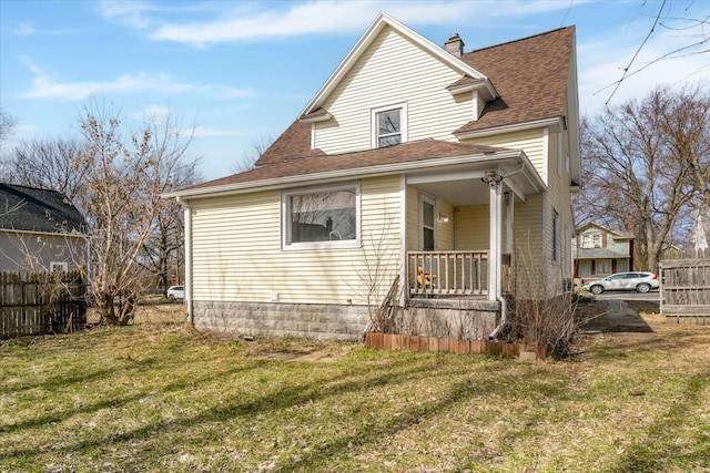 view of front of home with a front lawn, a porch, fence, roof with shingles, and a chimney