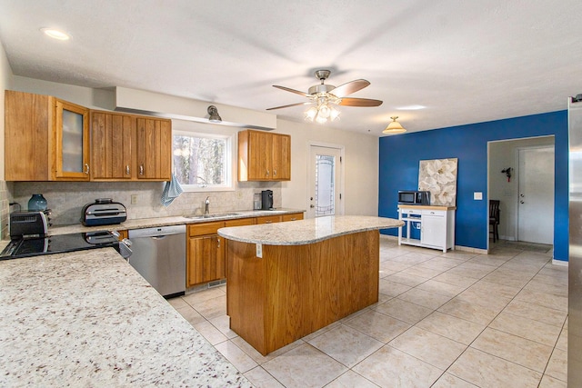 kitchen with dishwasher, decorative backsplash, brown cabinets, and a kitchen island