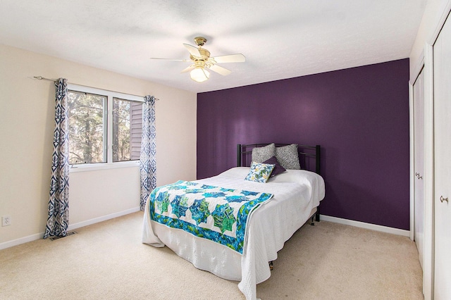 carpeted bedroom featuring visible vents, a ceiling fan, baseboards, and a closet