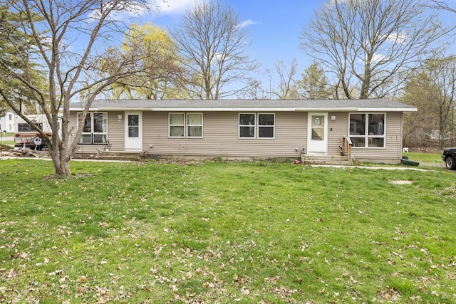 single story home featuring a front lawn and entry steps