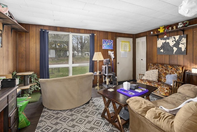 living room featuring wooden walls and wood finished floors