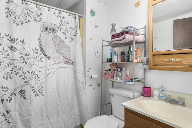 bathroom featuring curtained shower, toilet, and vanity