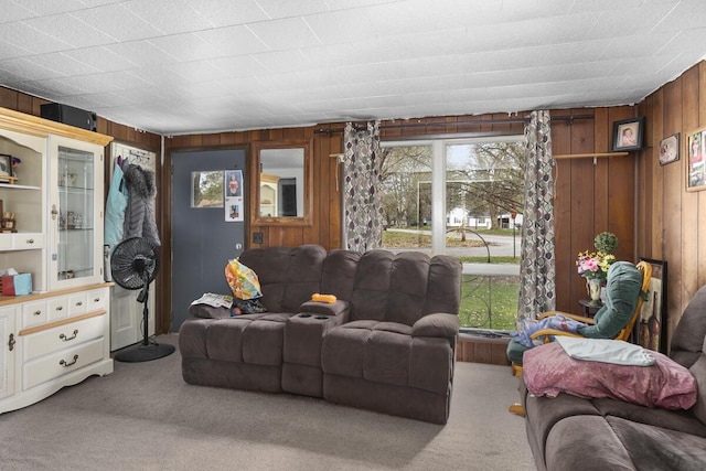 living room featuring wooden walls and carpet floors