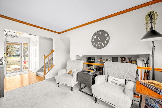 carpeted living room with stairs and ornamental molding