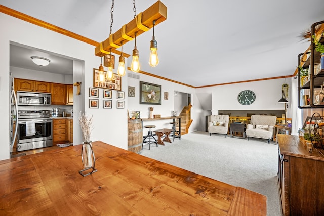 dining space with visible vents, carpet, and ornamental molding