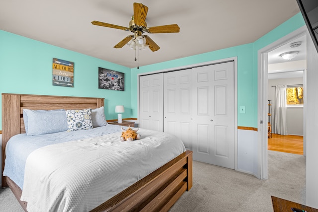 carpeted bedroom featuring a ceiling fan and a closet