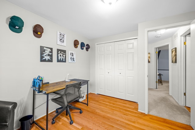 home office featuring visible vents, baseboards, and light wood-style floors