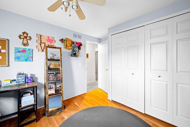 interior space with a closet, visible vents, light wood finished floors, and ceiling fan