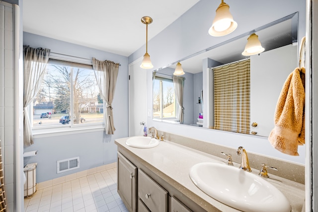 full bathroom with a sink, visible vents, and a healthy amount of sunlight