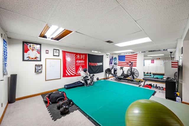 rec room featuring visible vents, carpet flooring, a paneled ceiling, and baseboards