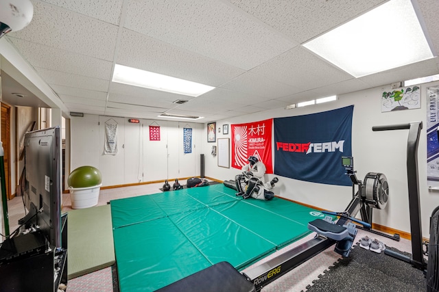 recreation room featuring a drop ceiling, visible vents, and baseboards