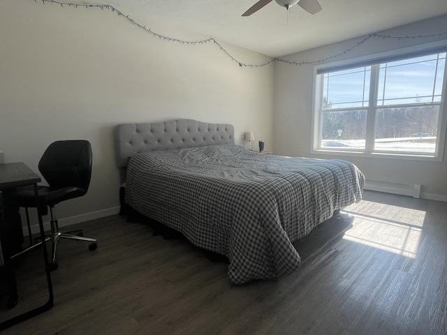 bedroom featuring baseboards, baseboard heating, and wood finished floors