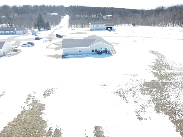 snowy aerial view featuring a view of trees