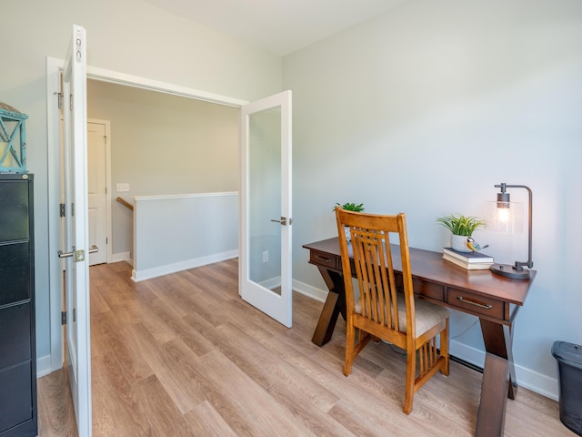 office space featuring light wood-style flooring and baseboards