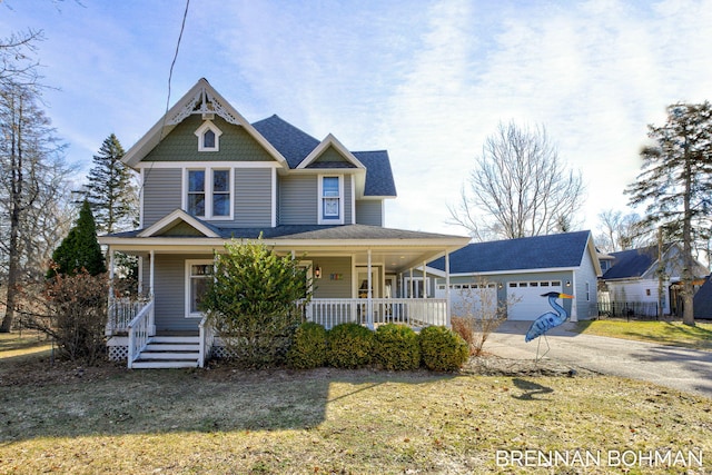 victorian home with concrete driveway, an attached garage, covered porch, and a front yard