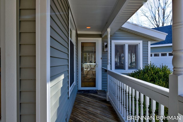 view of exterior entry featuring roof with shingles