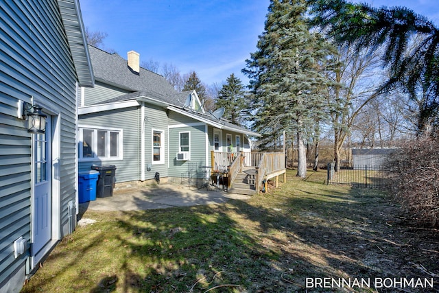 view of yard with a deck, cooling unit, a patio area, and fence