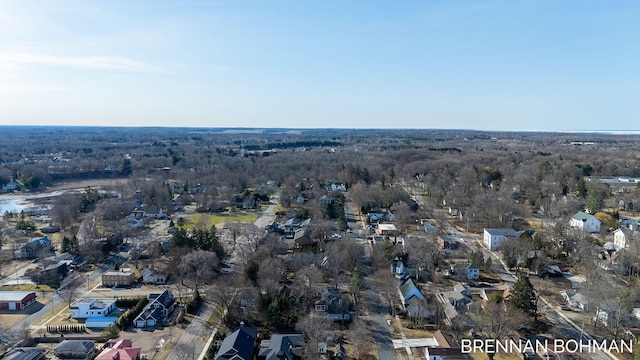 aerial view with a wooded view and a residential view