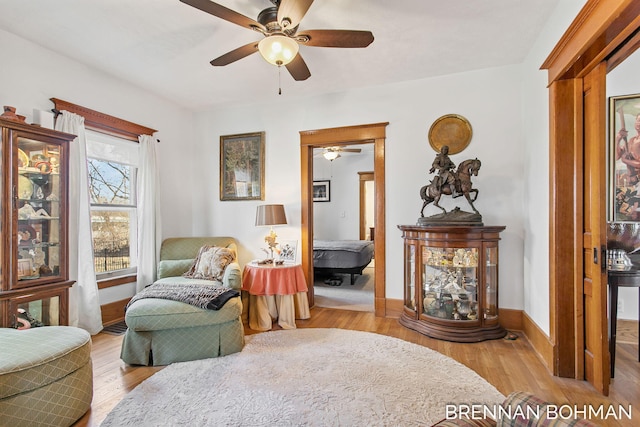 living area featuring wood finished floors and baseboards