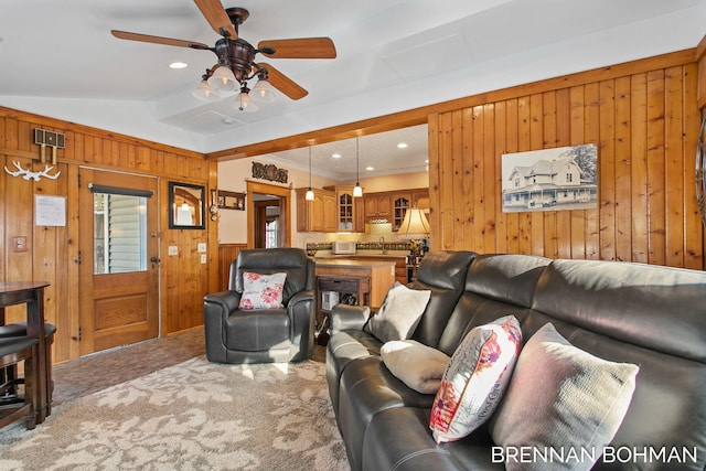 carpeted living area with recessed lighting, wood walls, a ceiling fan, and vaulted ceiling