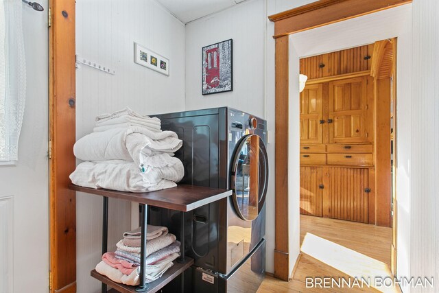 laundry area featuring light wood-style flooring and laundry area