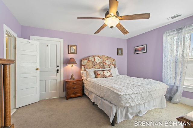 bedroom with visible vents, a ceiling fan, and carpet flooring