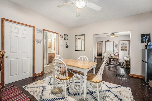 dining room with hardwood / wood-style floors, a ceiling fan, and baseboards